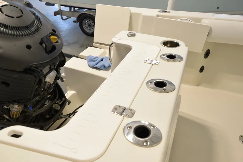 Slide: The Image of 2014 Sailfish 220 CC boat interior with engine and rod holders. - 16