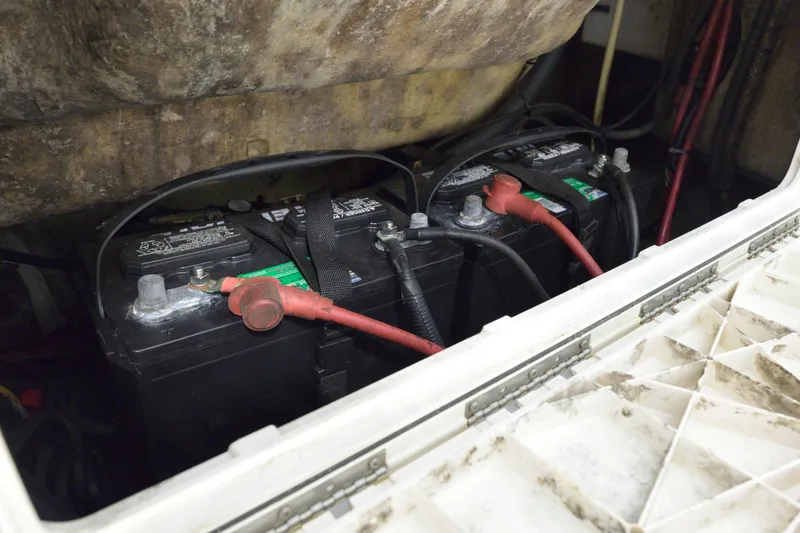 Slide: The Image of Battery compartment of a 2014 Sailfish 220 CC boat, showing connected cables. - 19
