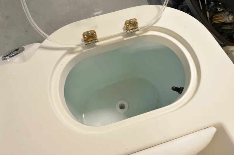 Slide: The Image of Open livewell on a 2014 Sailfish 220 CC boat, showcasing interior details. - 17
