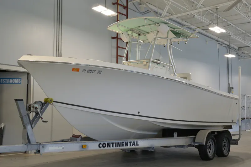 The Image of 2014 Sailfish 220 CC boat on Continental trailer in indoor storage facility. - 0