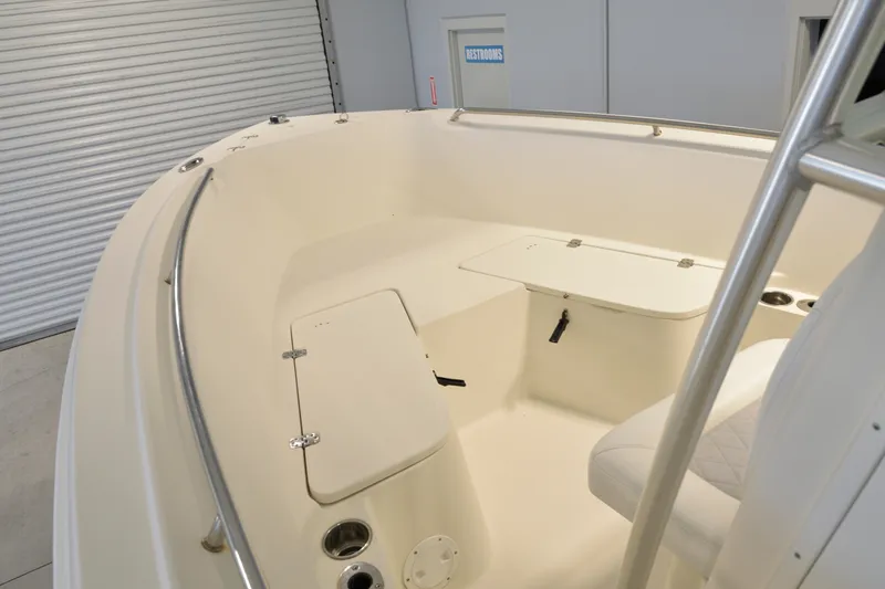 Slide: The Image of 2014 Sailfish 220 CC boat interior with storage compartments and seating. - 18