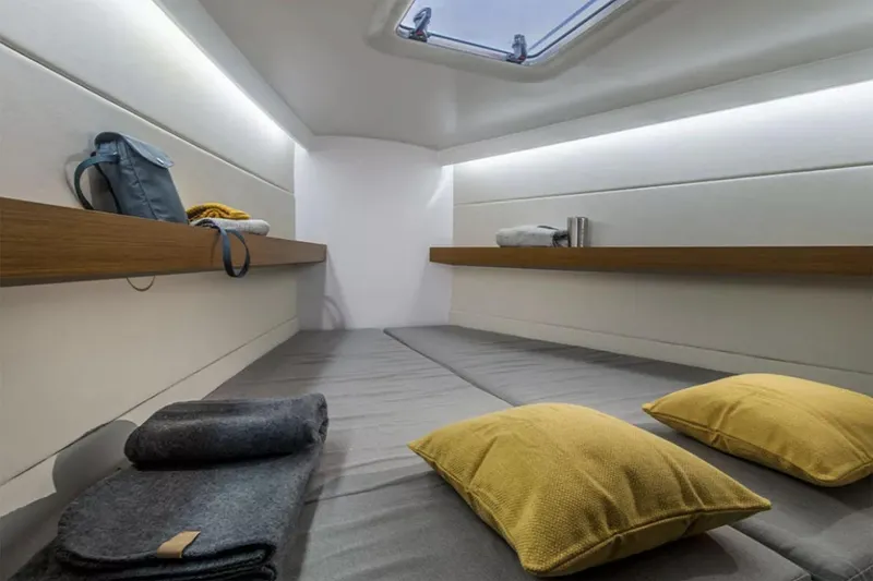 Slide: The Image of Manufacturer Provided Image: Cozy cabin interior of 2026 Beneteau First 36 yacht with modern design and soft lighting. - 6