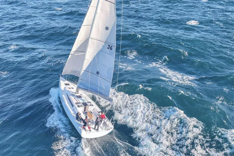 Slide: The Image of Manufacturer Provided Image: 2026 Beneteau First 36 sailing on open ocean, showcasing sleek design and performance. - 0