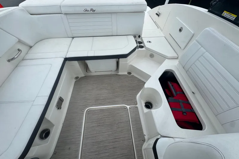 Slide: The Image of Interior of 2020 Sea Ray SPX 230 boat with white seating and storage compartments. - 46