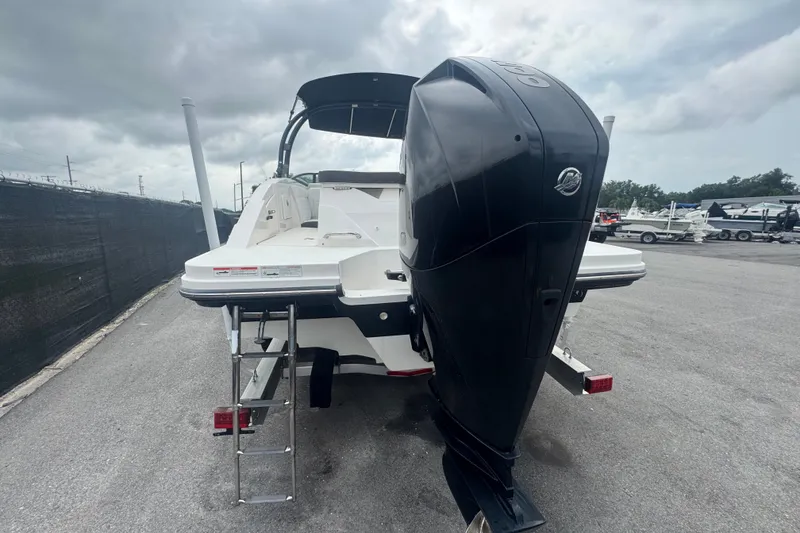 Slide: The Image of 2020 Sea Ray SPX 230 boat with outboard motor, parked on a cloudy day. - 7