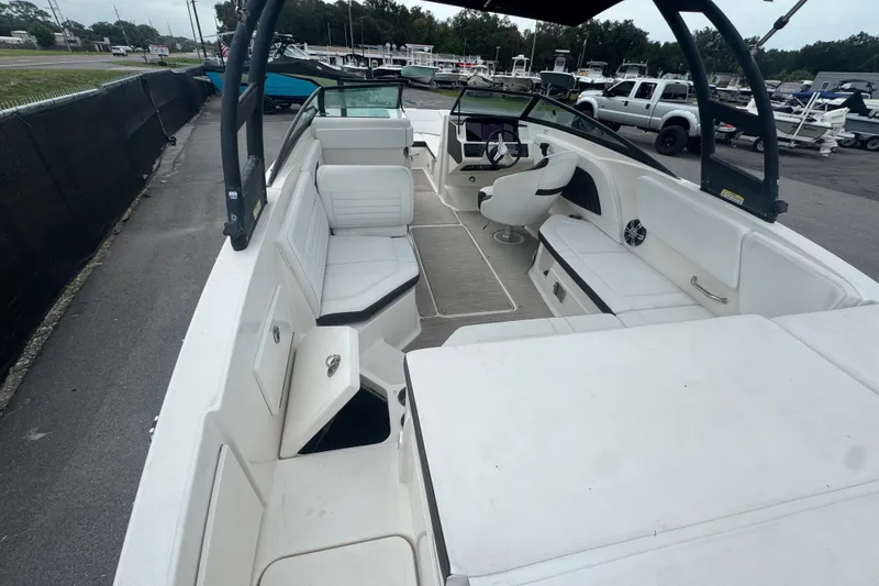 Slide: The Image of 2020 Sea Ray SPX 230 boat interior with white seating and modern dashboard. - 18