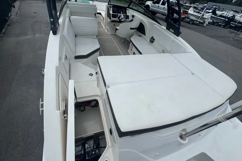 Slide: The Image of 2020 Sea Ray SPX 230 boat interior with seating and storage compartments. - 17