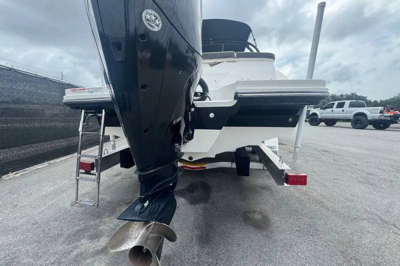 Slide: The Image of 2020 Sea Ray SPX 230 boat rear view with outboard motor and ladder. - 3
