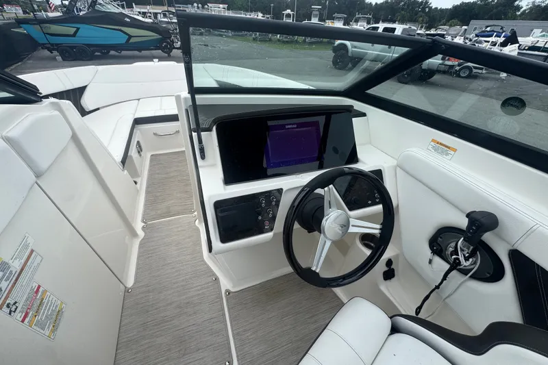 Slide: The Image of 2020 Sea Ray SPX 230 boat interior with steering wheel and control panel. - 30