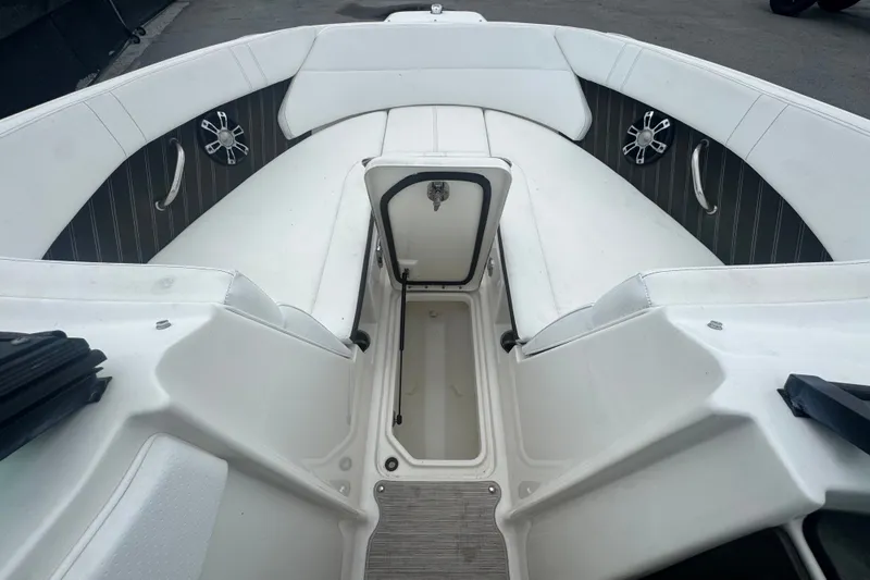 Slide: The Image of 2020 Sea Ray SPX 230 boat interior with white seating and storage compartment. - 35