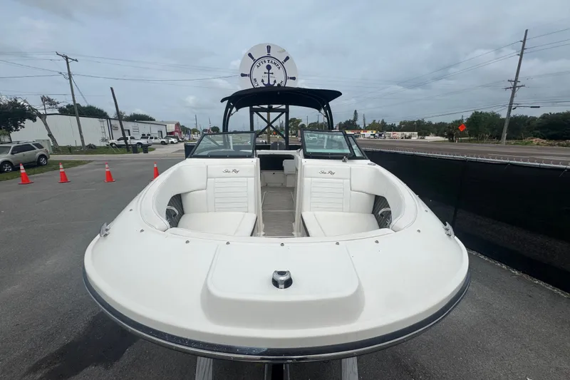 Slide: The Image of 2020 Sea Ray SPX 230 boat displayed outdoors, showcasing sleek design and spacious seating. - 12