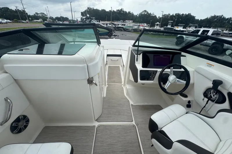 Slide: The Image of 2020 Sea Ray SPX 230 boat interior with modern dashboard and seating. - 27