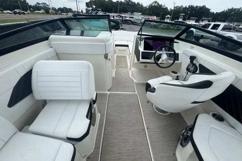 Slide: The Image of 2020 Sea Ray SPX 230 boat interior with white seating and modern dashboard. - 26