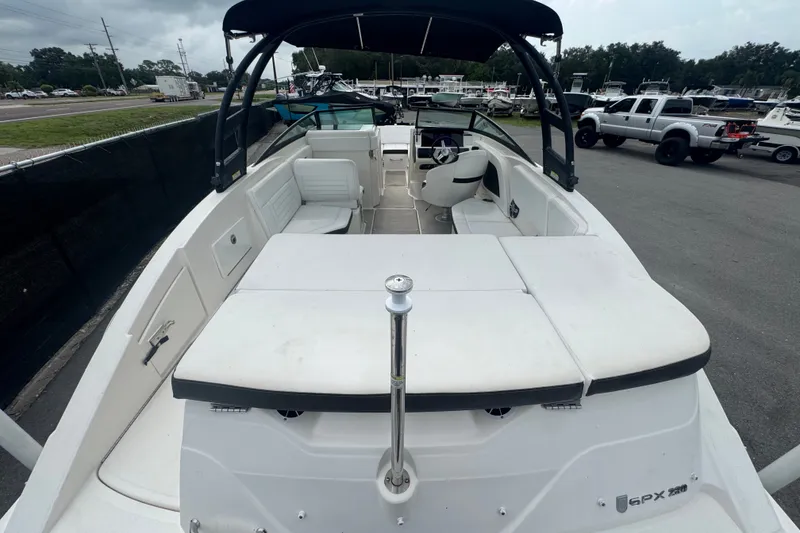 Slide: The Image of 2020 Sea Ray SPX 230 boat with spacious seating and sleek design, parked outdoors. - 15