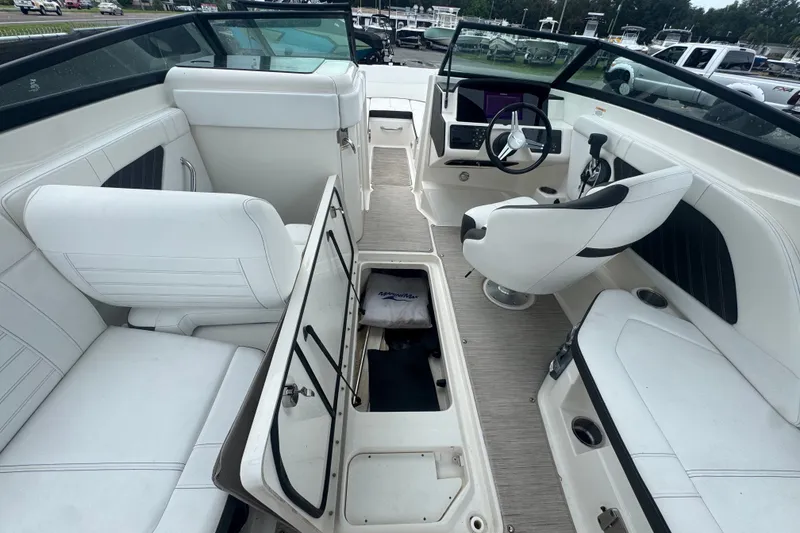 Slide: The Image of Interior of a 2020 Sea Ray SPX 230 boat with white seating and open storage. - 24