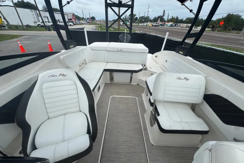 Slide: The Image of Interior view of a 2020 Sea Ray SPX 230 boat with white seating and open layout. - 40