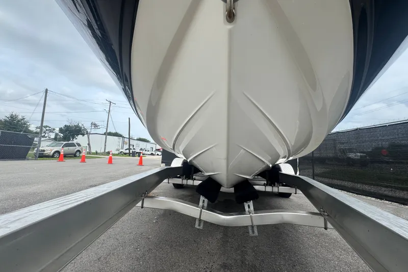 Slide: The Image of 2020 Sea Ray SPX 230 boat on trailer, viewed from below, in outdoor setting. - 14