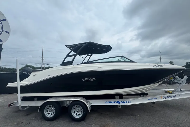 Slide: The Image of 2020 Sea Ray SPX 230 boat on trailer, black and white design, overcast sky. - 1
