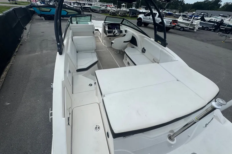 Slide: The Image of 2020 Sea Ray SPX 230 boat interior with white seating and sleek design. - 16