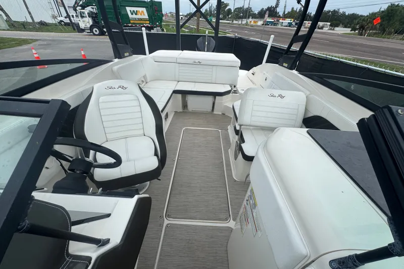 Slide: The Image of Interior of a 2020 Sea Ray SPX 230 boat with white seating and steering wheel. - 39