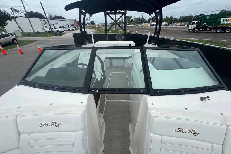 Slide: The Image of 2020 Sea Ray SPX 230 boat with open cockpit and windshield, parked outdoors. - 38