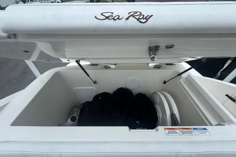 Slide: The Image of 2020 Sea Ray SPX 230 boat storage compartment open, showcasing spacious interior. - 50