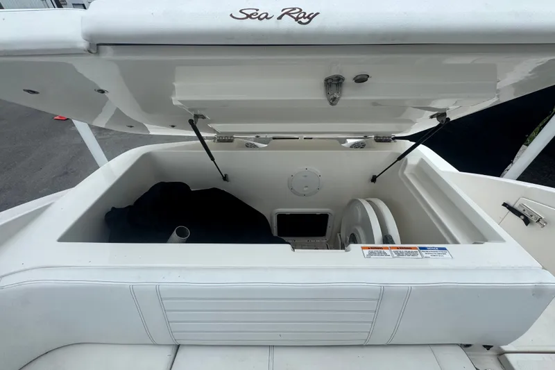 Slide: The Image of Open storage compartment on a 2020 Sea Ray SPX 230 boat, showcasing interior space. - 49