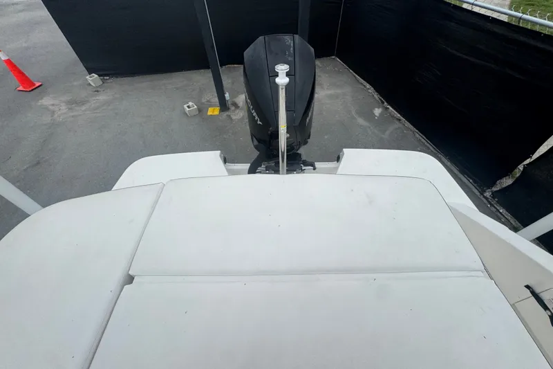Slide: The Image of 2020 Sea Ray SPX 230 boat with outboard motor, viewed from the rear on a concrete surface. - 52