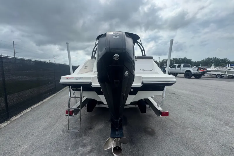 Slide: The Image of 2020 Sea Ray SPX 230 boat with outboard motor, parked on a cloudy day. - 4