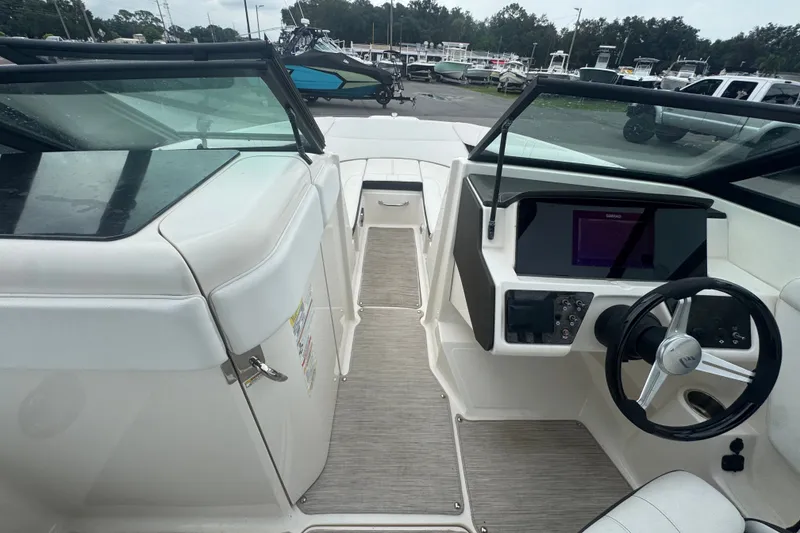 Slide: The Image of 2020 Sea Ray SPX 230 boat interior with steering wheel and dashboard controls. - 28