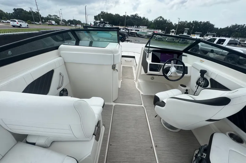 Slide: The Image of 2020 Sea Ray SPX 230 boat interior with white seating and modern dashboard. - 25