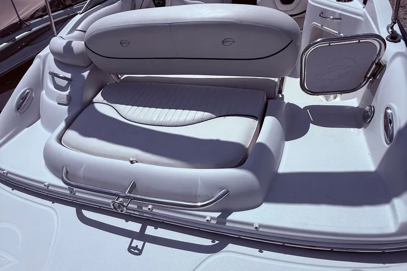 Slide: The Image of 2008 Crownline 220 EX boat interior with cushioned seating and storage compartment. - 13