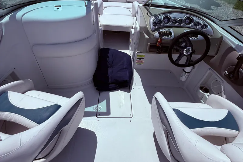 Slide: The Image of Interior of a 2008 Crownline 220 EX boat, featuring steering wheel and seating. - 8