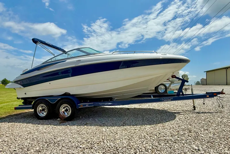 The Image of 2008 Crownline 220 EX boat on trailer under clear blue sky. - 1