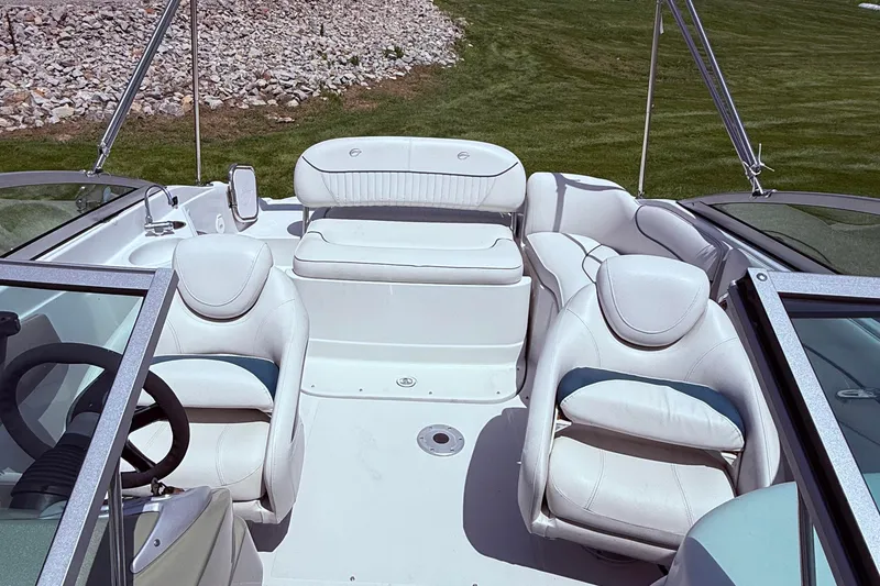 Slide: The Image of Interior of 2008 Crownline 220 EX boat with white seating and steering wheel. - 12