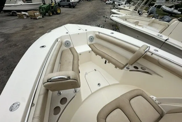 Slide: The Image of 2016 Scout 255 LXF boat interior with beige seating and cup holders. - 17