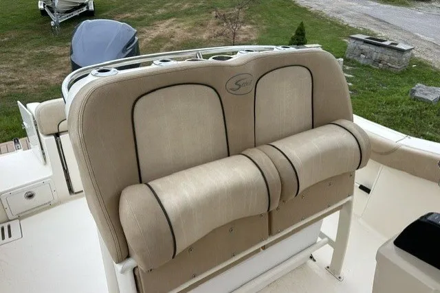 Slide: The Image of 2016 Scout 255 LXF boat with beige cushioned seating and cup holders. - 7