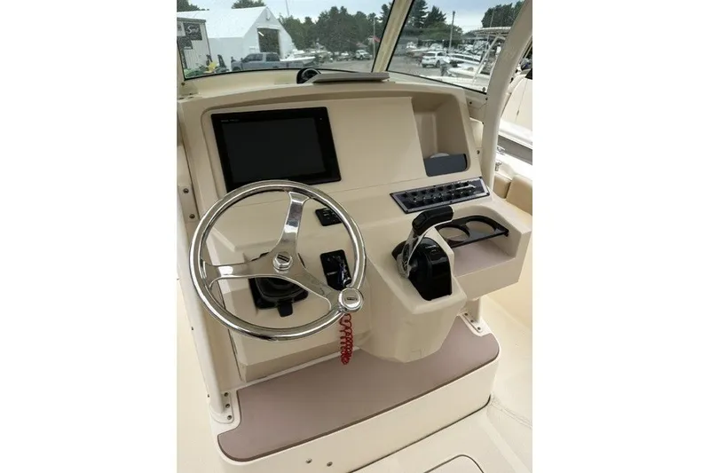 Slide: The Image of Helm of 2016 Scout 255 LXF boat with steering wheel and controls. - 5