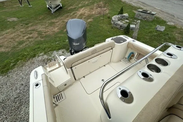 Slide: The Image of 2016 Scout 255 LXF boat deck with seating and outboard motor. - 13
