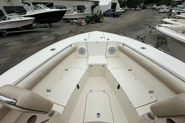Slide: The Image of 2016 Scout 255 LXF boat interior with seating, docked at a marina. - 9