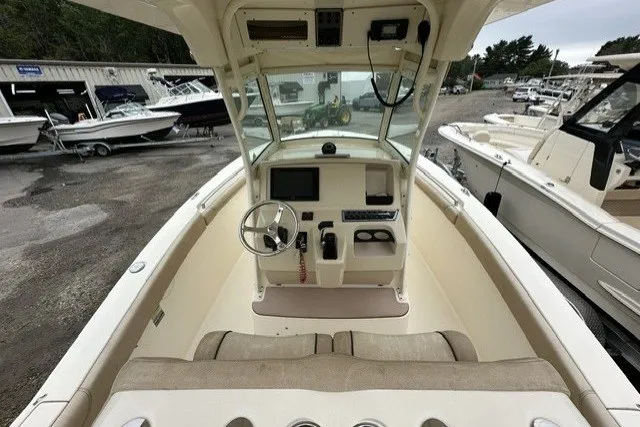 Slide: The Image of 2016 Scout 255 LXF boat interior with steering wheel and control panel. - 15