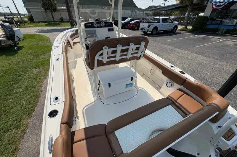 Slide: The Image of 2027 Pioneer 202 Islander boat interior with brown seating and modern dashboard. - 12