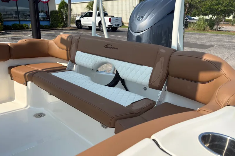 Slide: The Image of 2027 Pioneer 202 Islander boat interior with brown and white cushioned seating. - 11