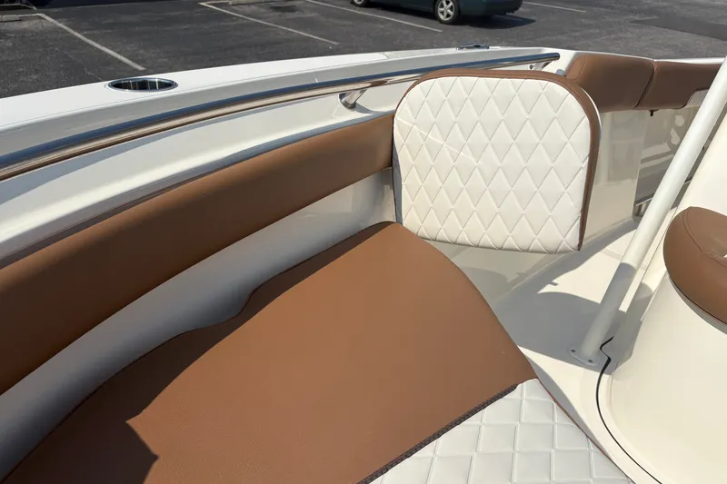 Slide: The Image of Luxurious seating on 2027 Pioneer 202 Islander boat with brown and white upholstery. - 30