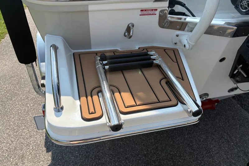 Slide: The Image of 2027 Pioneer 202 Islander boat swim platform with foldable ladder and teak-style decking. - 8