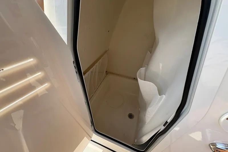 Slide: The Image of Interior view of 2027 Pioneer 202 Islander boat compartment with storage space. - 26