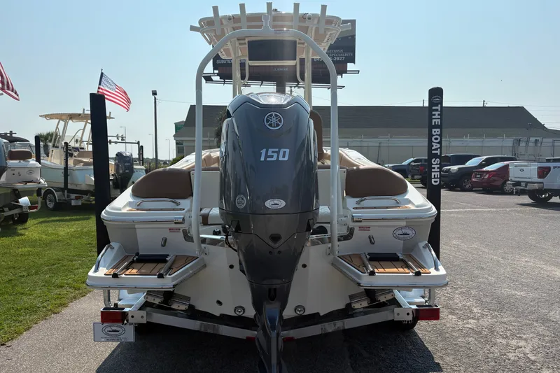 Slide: The Image of 2027 Pioneer 202 Islander boat with Yamaha 150 engine at dealership display. - 2