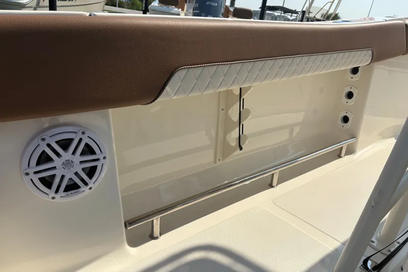 Slide: The Image of Interior view of a 2027 Pioneer 202 Islander boat featuring a speaker and cushioned panel. - 18