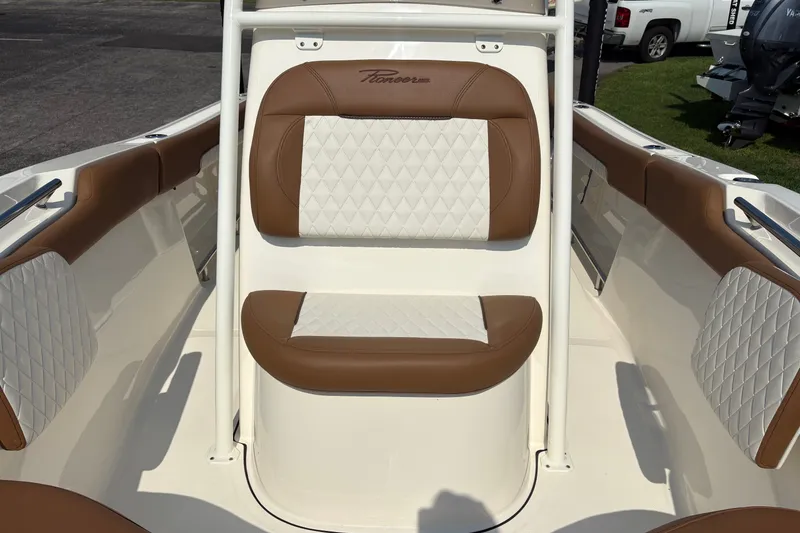 Slide: The Image of 2027 Pioneer 202 Islander boat interior with brown and white cushioned seating. - 28