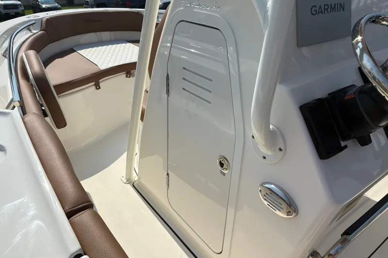 Slide: The Image of 2027 Pioneer 202 Islander boat interior with Garmin equipment and cushioned seating. - 25